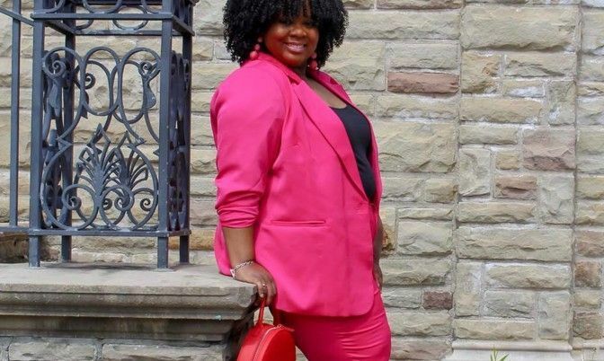 hot pink suit paired with a red handbag