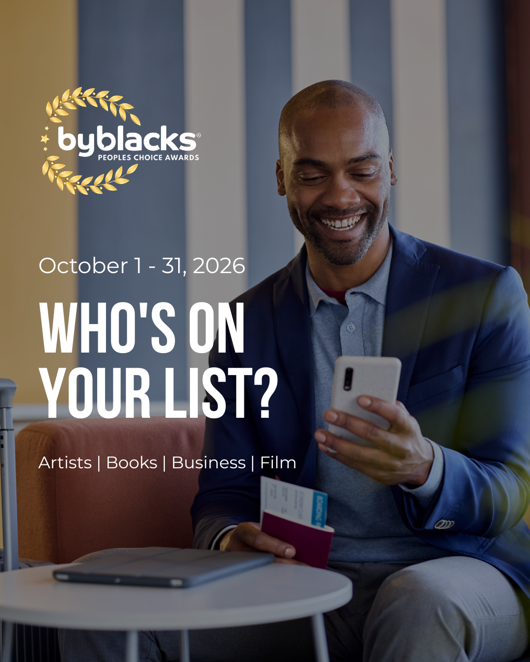 A promotional poster for the ByBlacks People’s Choice Awards. On the right, a smiling Black man in a navy blazer and gray shirt sits in a chair, holding a smartphone and a small booklet or card. A tablet rests on a round white table in the foreground. The background features tall blue-gray and beige vertical panels, with a leafy green plant visible along the right edge. On the left, a gold laurel wreath surrounds the white “byblacks” logo and award title. White text below announces the voting period and award categories.