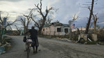 An elderly man walks his bicycle down a devastated street in Black River, Jamaica, after Hurricane Melissa, Josh Morgerman via Facebook.
