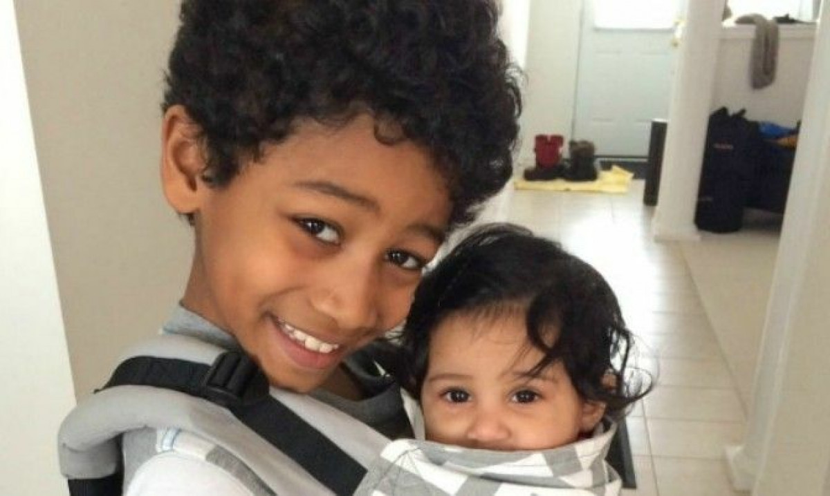 Isaiah, 11, with his baby sister.