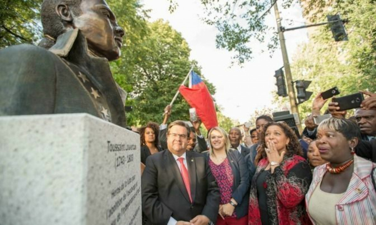 Montreal Mayor Denis Coderre looks on with artist Dominique Dennery (in red) as the bust is unveiled.