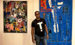 Carl Cassell in his home in front of Artwork by Raquel DaSilva &amp; Leandro Illescas